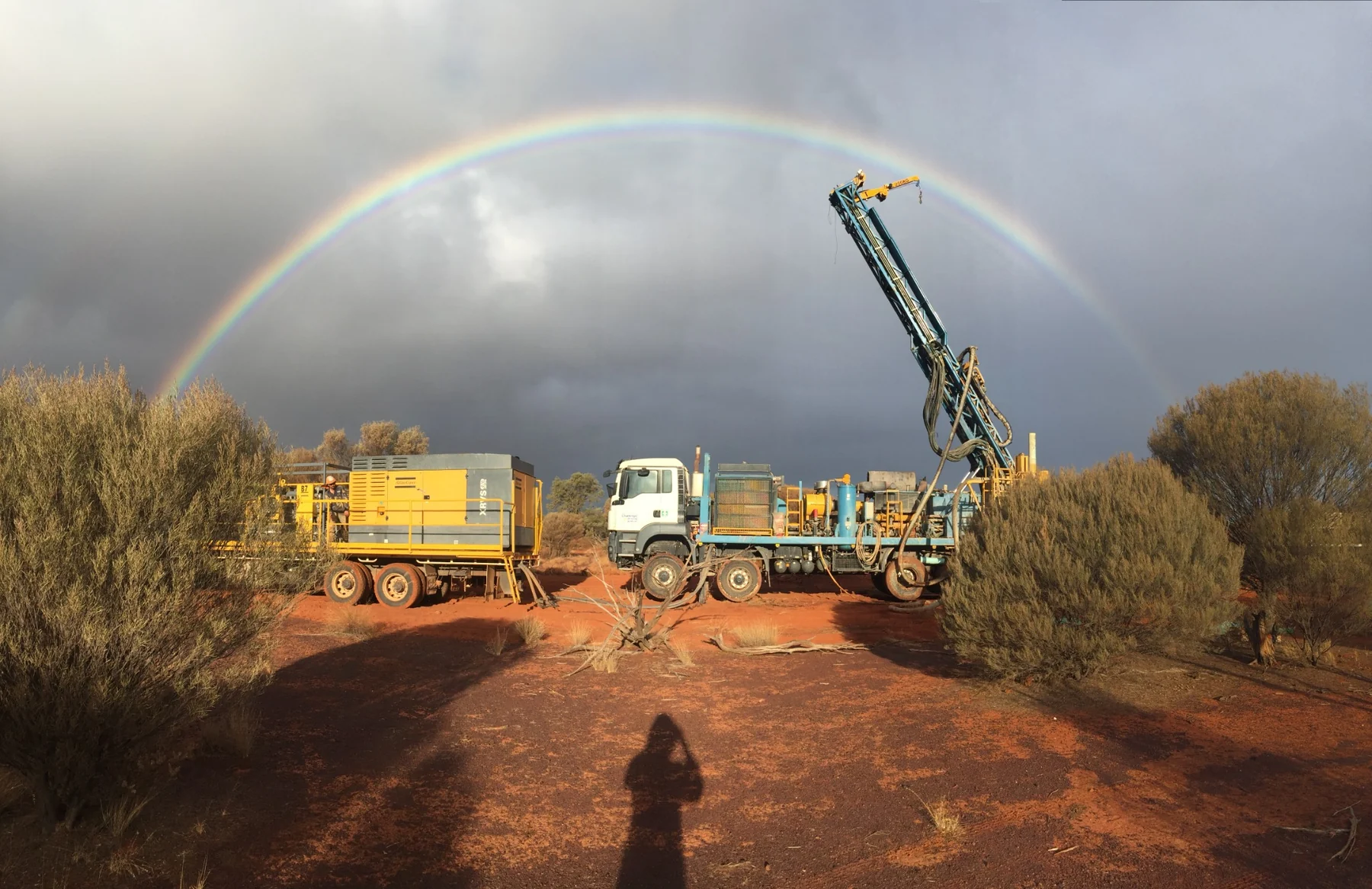 Drill rig in remote Western Australia beneath a rainbow